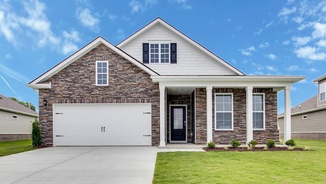 view of front of home with a front yard and a garage