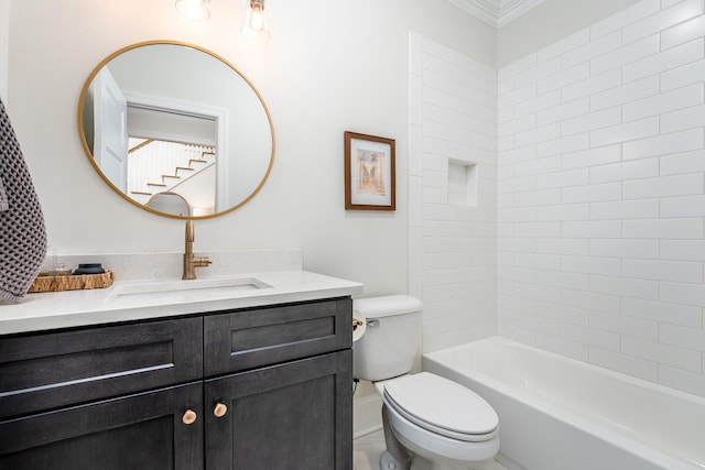 full bathroom featuring tiled shower / bath, vanity, ornamental molding, and toilet