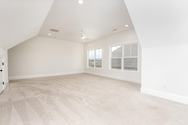 bonus room featuring light carpet, ceiling fan, and lofted ceiling