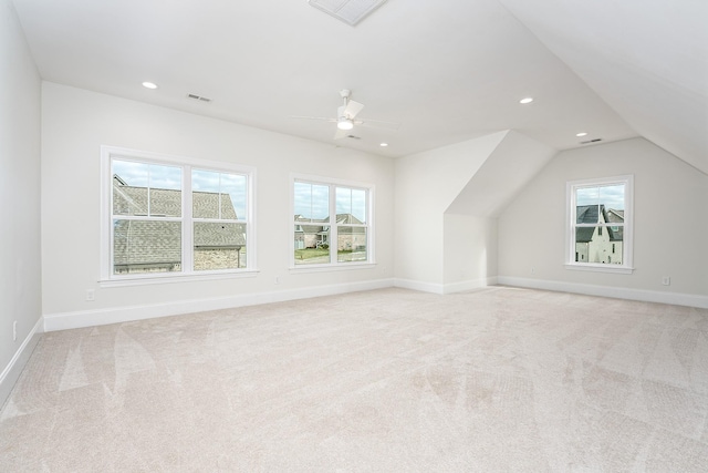 additional living space featuring light carpet, ceiling fan, and vaulted ceiling