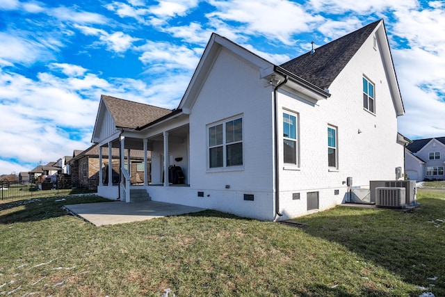 view of side of home with a patio, central AC unit, and a lawn