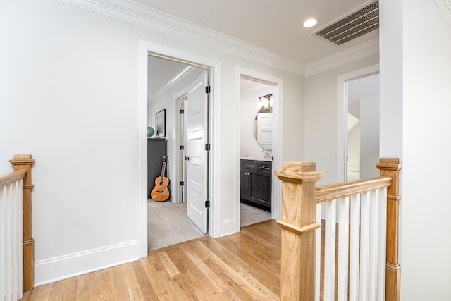 corridor featuring crown molding and light wood-type flooring