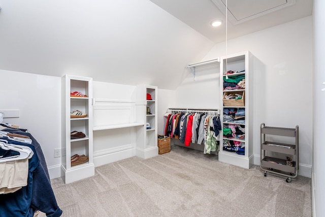 walk in closet featuring light carpet and vaulted ceiling