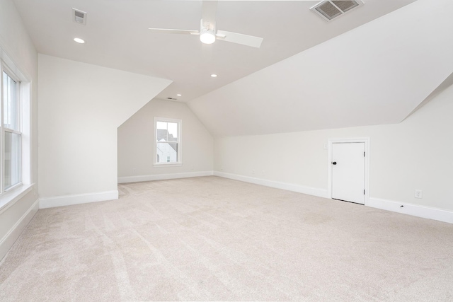 additional living space with light carpet, ceiling fan, and lofted ceiling