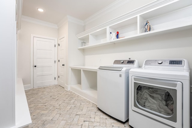 laundry area featuring separate washer and dryer and crown molding