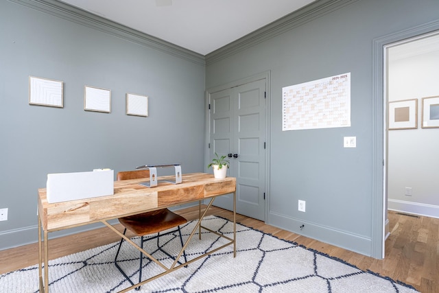 office featuring hardwood / wood-style flooring and crown molding