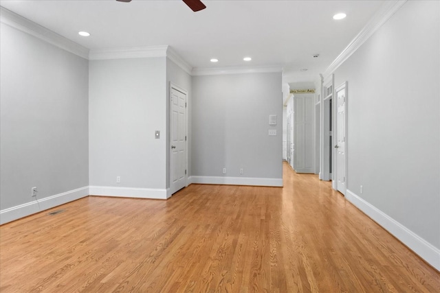 spare room with crown molding, light hardwood / wood-style floors, and ceiling fan