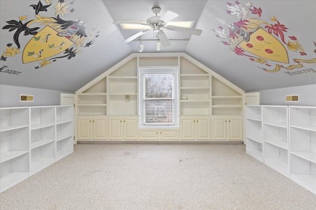 bonus room with light carpet, built in features, ceiling fan, and lofted ceiling