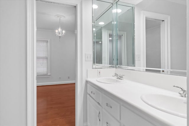 bathroom featuring vanity, crown molding, and wood-type flooring