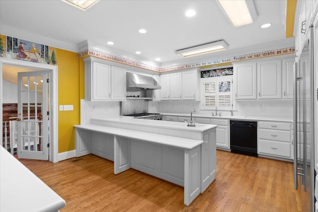 kitchen with light hardwood / wood-style flooring, dishwasher, white cabinets, kitchen peninsula, and wall chimney exhaust hood