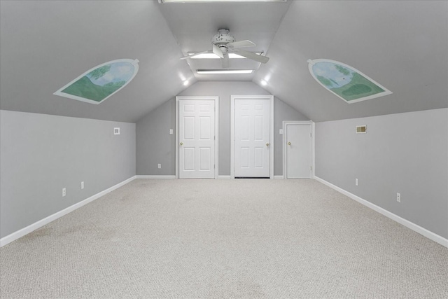 bonus room featuring ceiling fan, lofted ceiling, and carpet