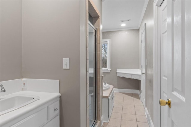 bathroom featuring tile patterned flooring, vanity, a shower with door, and ornamental molding