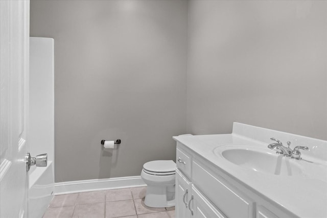 bathroom featuring tile patterned flooring, vanity, a washtub, and toilet