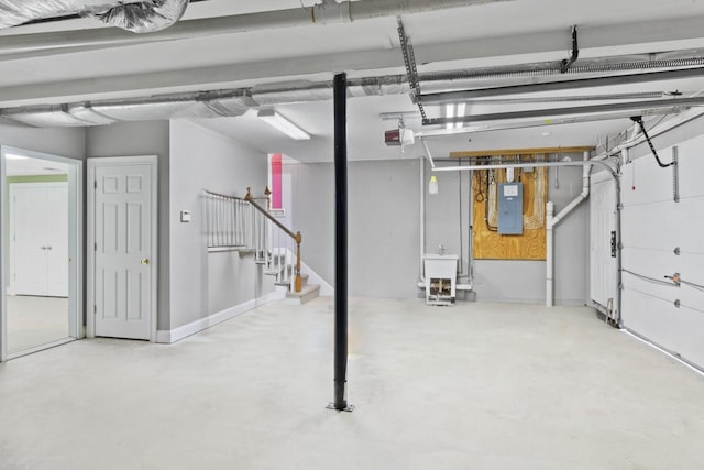 garage featuring a garage door opener and electric panel