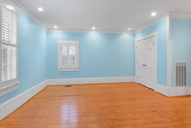 unfurnished room with crown molding and light hardwood / wood-style floors