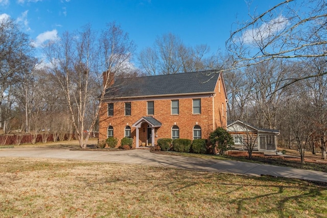 colonial-style house with a front lawn