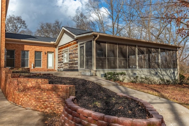 rear view of property with a sunroom