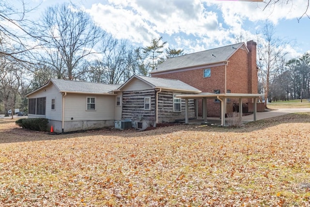 rear view of property featuring a patio and central air condition unit