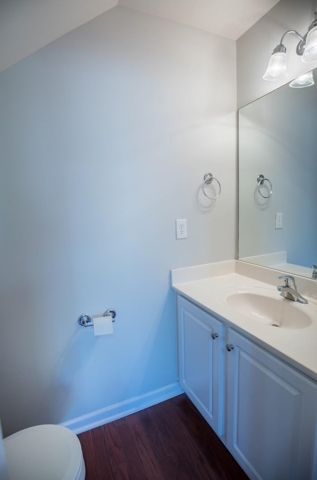 bathroom featuring vanity, hardwood / wood-style flooring, and toilet