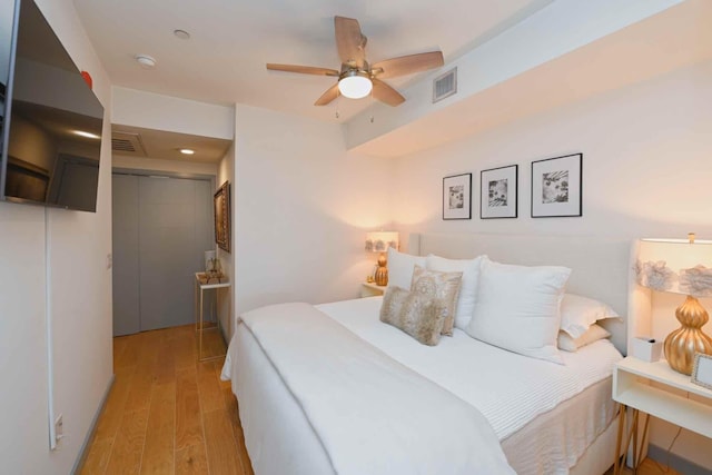 bedroom with ceiling fan, a closet, and light wood-type flooring