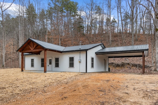 rear view of property with a carport