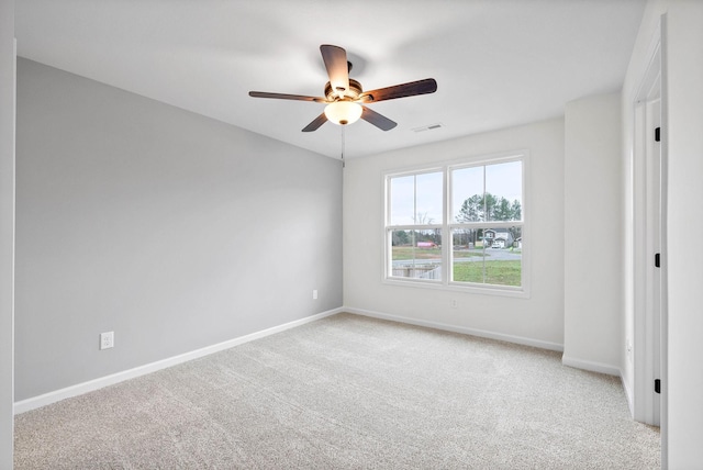 empty room featuring visible vents, baseboards, a ceiling fan, and carpet floors