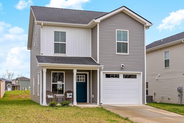 traditional-style home with a porch, a shingled roof, a front lawn, concrete driveway, and a garage