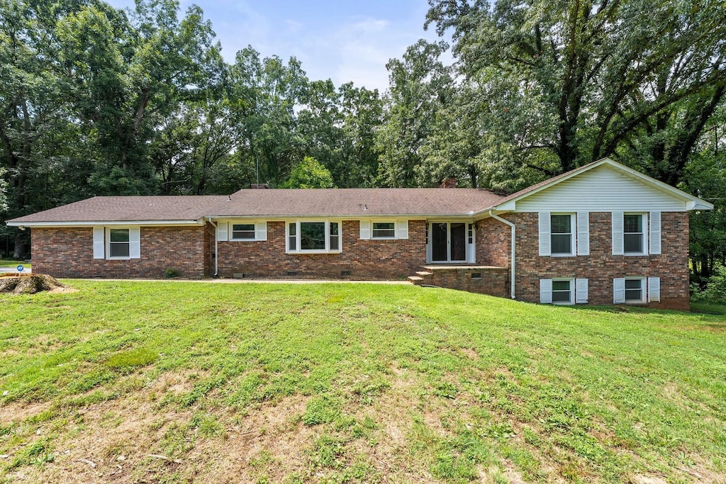 ranch-style house with a front lawn