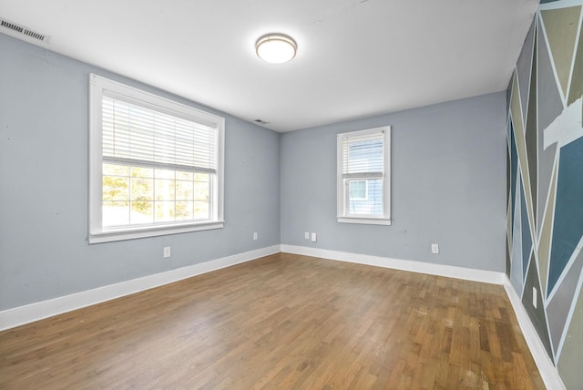 spare room with hardwood / wood-style floors