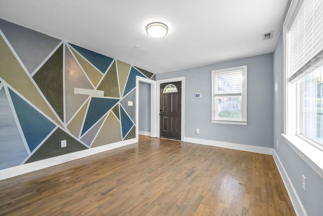 unfurnished room with wood-type flooring