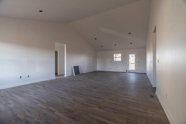 unfurnished living room with dark hardwood / wood-style flooring and high vaulted ceiling