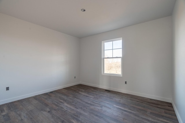 spare room with dark hardwood / wood-style floors