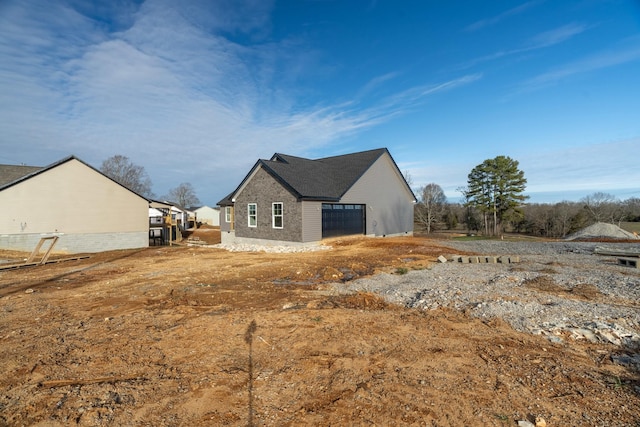 view of side of property with a garage