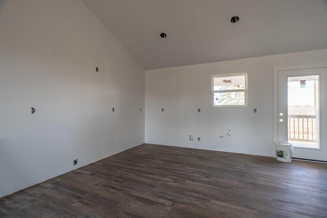 spare room with dark hardwood / wood-style flooring and lofted ceiling