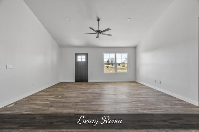 foyer entrance with vaulted ceiling, ceiling fan, wood finished floors, and baseboards