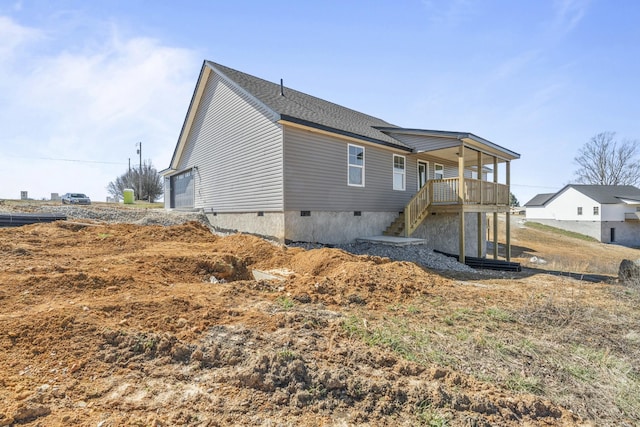 exterior space featuring crawl space and stairs