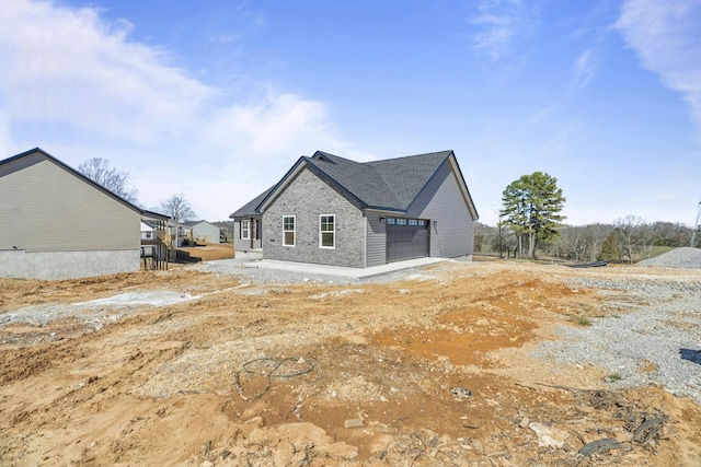 back of property with a garage