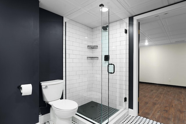 bathroom featuring hardwood / wood-style floors, toilet, and walk in shower