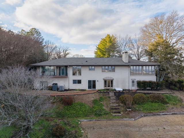 rear view of house with central air condition unit