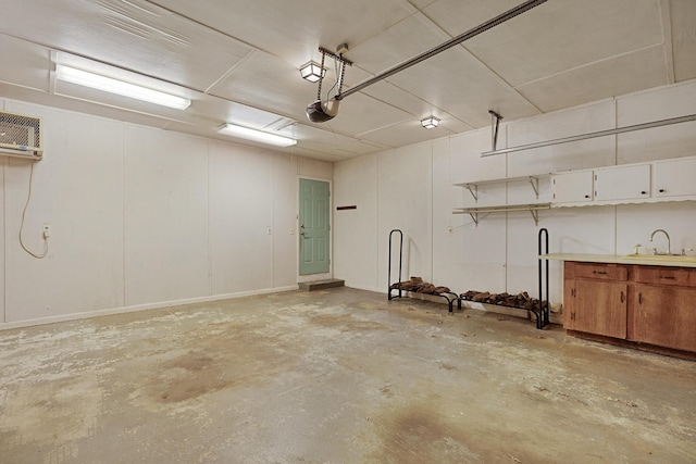 garage featuring a garage door opener and a wall mounted AC