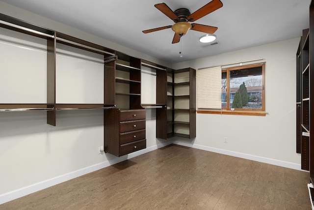 spacious closet with ceiling fan and wood-type flooring