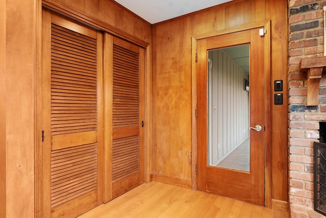 interior space featuring light hardwood / wood-style floors and wooden walls