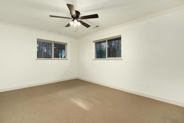 carpeted empty room featuring ceiling fan and crown molding