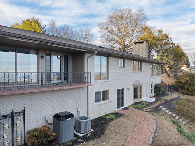 back of property featuring central AC