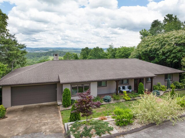 540 N Crest Ct, Chattanooga, TN 37404 - ranch-style home with an attached garage, driveway, a chimney, brick siding, and a shingled roof
