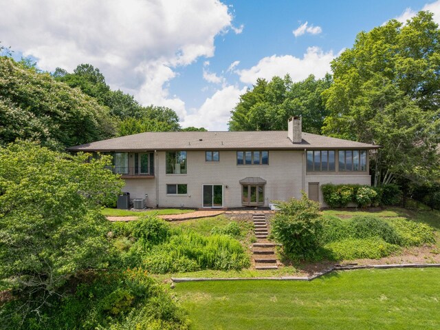 540 N Crest Ct, Chattanooga, TN 37404 - back of property featuring a chimney, a lawn, stairway, brick siding, and central AC unit