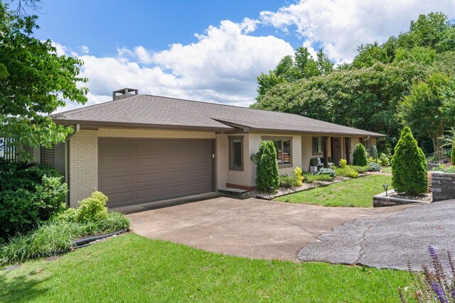 540 N Crest Ct, Chattanooga, TN 37404 - single story home with brick siding, an attached garage, concrete driveway, and a front lawn