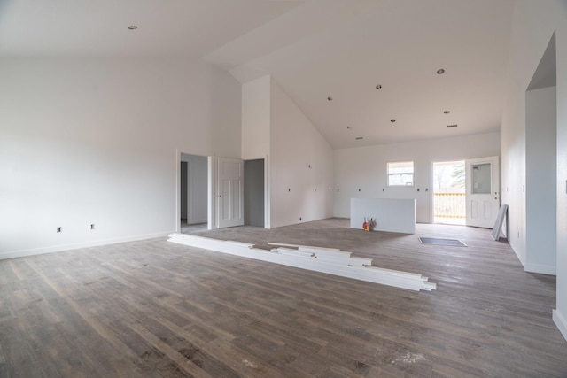 unfurnished living room featuring hardwood / wood-style flooring and high vaulted ceiling