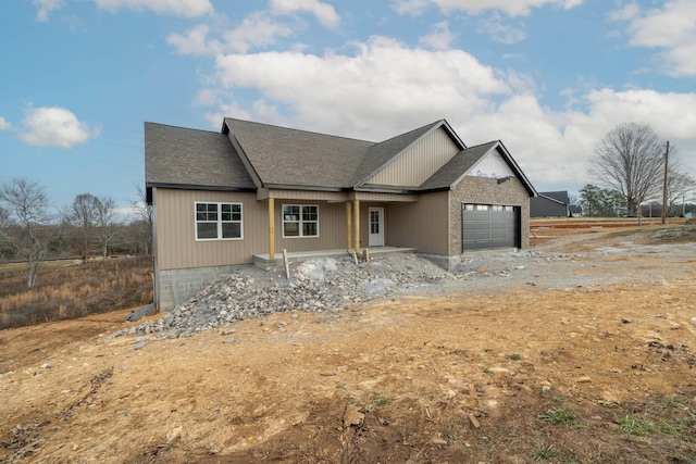 view of front facade featuring covered porch and a garage