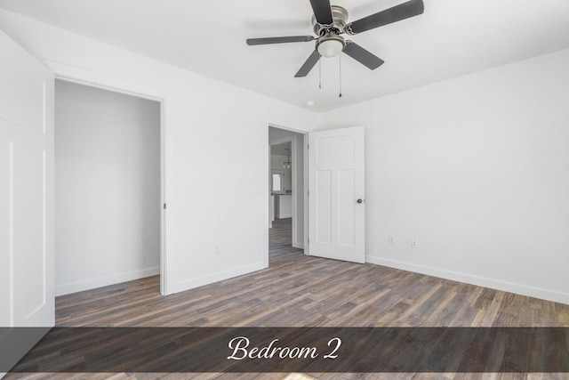 unfurnished bedroom featuring ceiling fan, baseboards, and wood finished floors